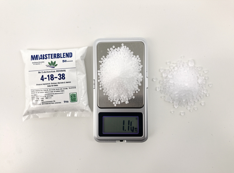 Masterblend 4-18-38, calcium nitrate, and Epsom salt in three piles on a bench with a 0.1 g pocket scale